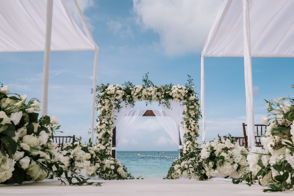 Luxury flower arch rosewood beach wedding