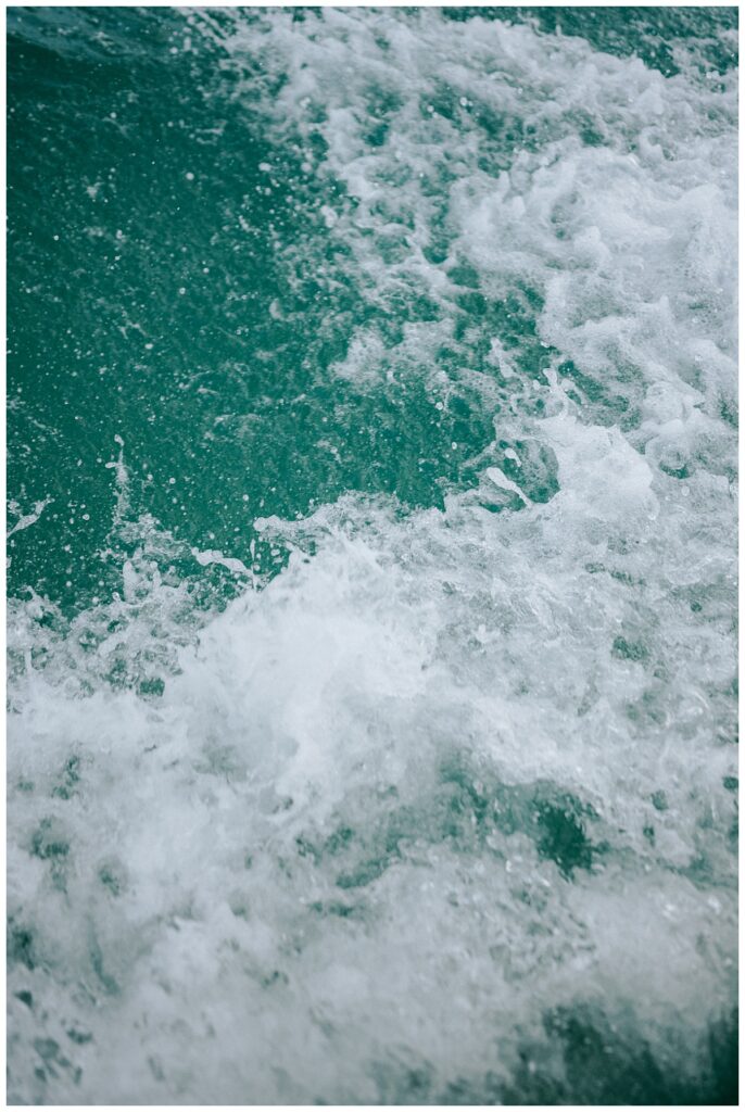 Boat wake in bright turquoise Exuma water en route to the sandbar.